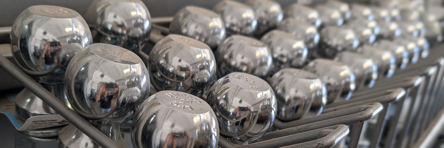 The interior of the APC Trailers service facility with a Cargo Express enclosed trailer on display